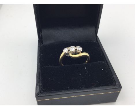 An 18ct gold three stone diamond ring. Approx weight 3.4 grams, approx size K.