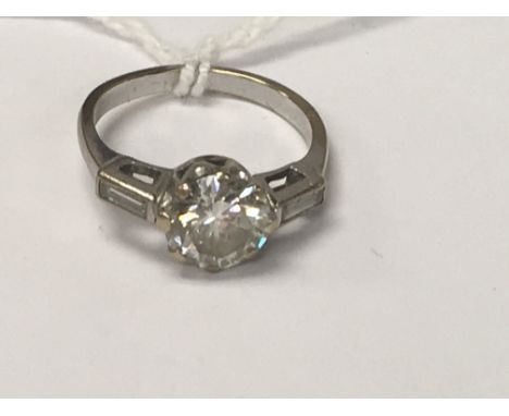 A white gold ring inset with a solitaire diamond 1ct aprox size K .