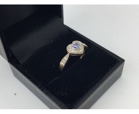 A 9ct gold stone set heart shaped ring. Approx weight 2.6 grams, size N.