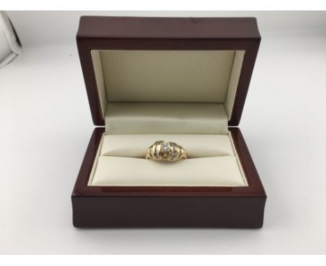 An 18ct diamond set cluster ring set with brilliant cut and baguette cut diamonds. Approx weight M Approx weight 6.7grams.