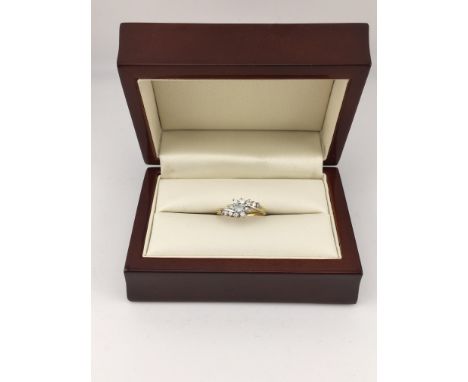 A yellow metal ring set with a blue stone and diamonds. Approx weight 2.81 grams, Approx size L.