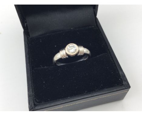 An 18ct white gold rub set solitaire ring. Approx weight 5.6 grams, size I.