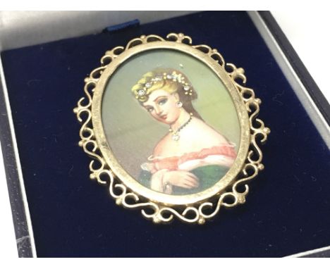 A 9ct gold miniature portrait brooch , 12.7g. Postage category a
