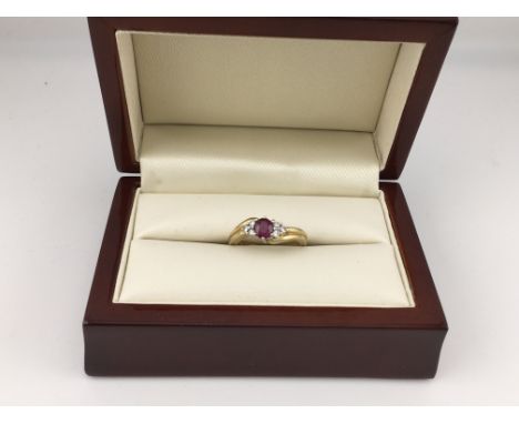 An 18ct ruby and diamond set ring. Approx weight 4.41 grams Approx size L.