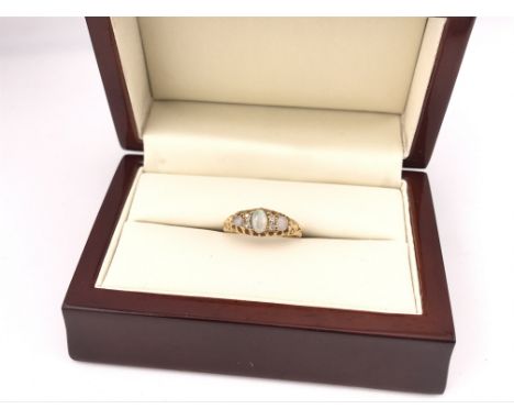 A yellow metal Opal set ring. Approx size N, approx weight 2.54 grams.