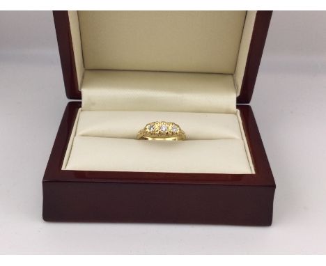 An 18ct gold ring set with three diamonds. Approx weight 3.69 grams, approx size L.
