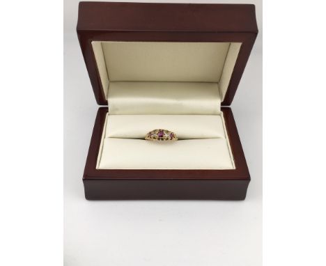 An 18ct diamond and ruby set ring. Approx weight 2.68 grams, Approx size K.