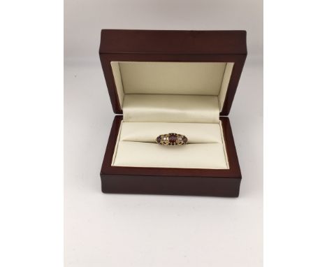 An 18ct garnet and diamond set ring. Approx weight 3.9 grams, size L.