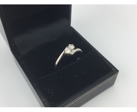 An 18ct white gold diamond set ring with two brilliant cut diamonds. Approx weight 3.4 grams. Size L.