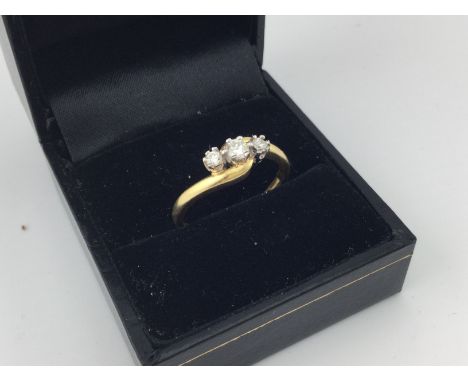 An 18ct gold diamond three stone ring. Approx weight 3.44 grams, size Q.