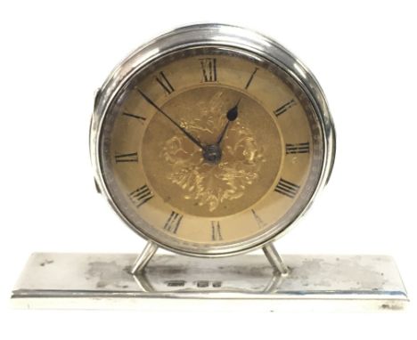 A hallmarked silver dressing table clock. 7cm wide. This lot cannot be posted. NO RESERVE