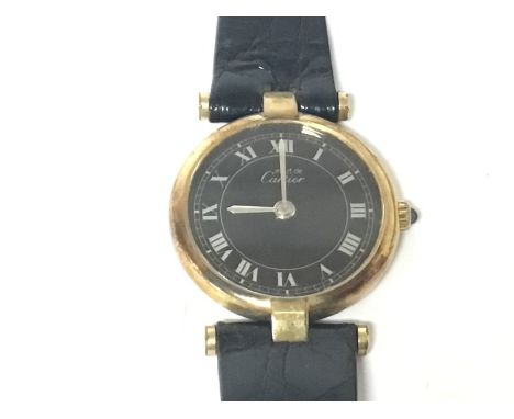 A ladies Cartier Argent watch 925 with gold plating with a black dial and silvered Roman numerals blue sapphire adjustment cr