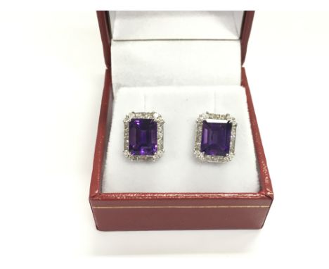 A pair of 18ct white gold large stud earring set with step cut eye clean amethyst's surround by diamonds. Postage A