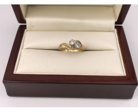 An 18ct diamond set ring with two central diamonds and diamonds flanking the central stones. Approx 3.3 grams, approx size H.
