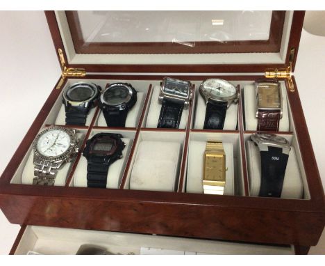 A walnut watch case containing gents designer watches digital watches and copy watches sold as seen.