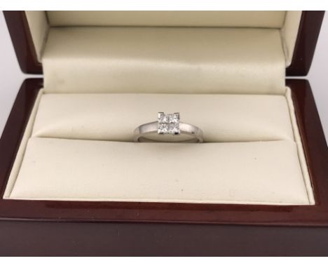 An 18ct white gold princess cut four diamond solitaire ring. Approx weight 2.4grams, approx size I 1/2.