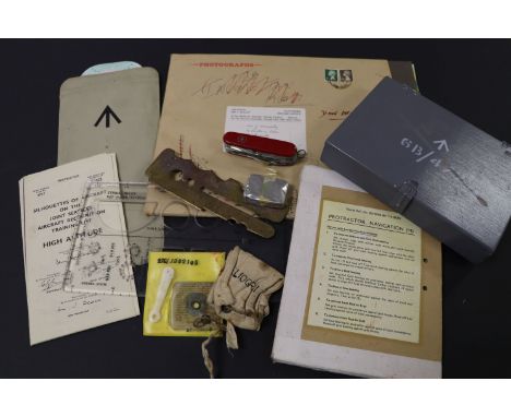 Box of vintage RAF Survival items including Swiss Army Knife, Navigation Guides, Silhouettes of Aircraft, Distance Measuremen