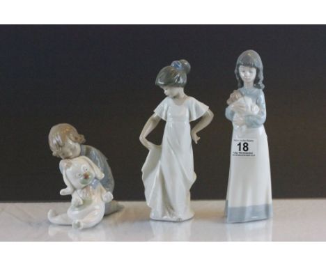 Three Nao Figurines to include a girl with puppy, child with a large toy & number 1110