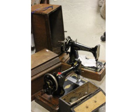 Two cased vintage Singer sewing machines one dated 1913  with manual together with a boxed vintage Gem  mincer with booklet a