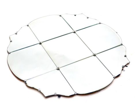A decorative wall mirror, of floral outline, set with floral rosettes, with nine sections of glass, 90cm x 93cm. 