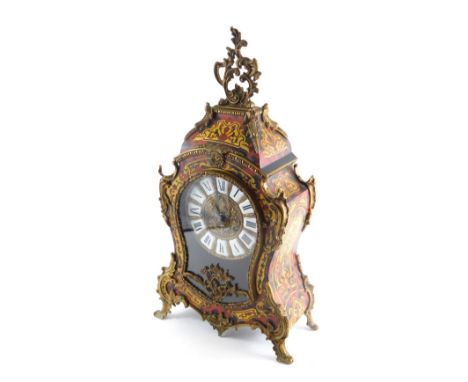 A Continental Boulle table clock, surmounted by a pierced scroll and floral finial,  raised above an enamel 15cm Roman numeri