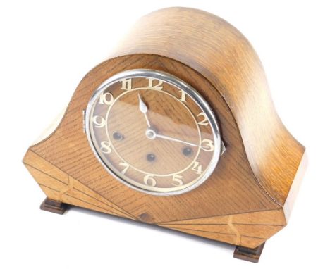 A mid 20thC Art Deco oak chiming mantel clock, with 16cm diameter Arabic dial, in shaped case with eight day chiming movement