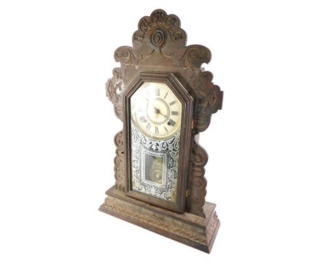 An American walnut ginger bread type mantel clock, made by the Ansonia Clock Company, 58cm high. 