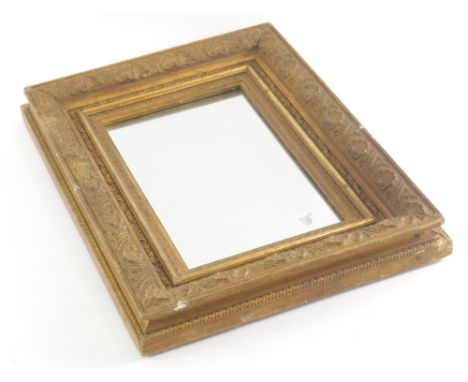 A small gilt gesso rectangular mirror, the frame decorated with shells, leaves, etc., 28cm x 37cm.