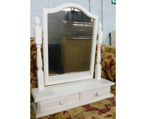 A table mirror in white, with turned supports, plain serpentine glass and two drawers, 58cm high.