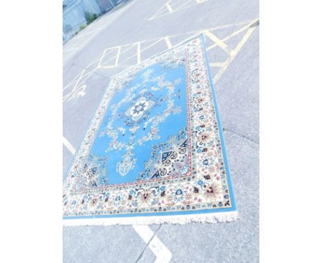 A floral machine woven Turkish style carpet, on a blue ground, 350cm x 253cm.