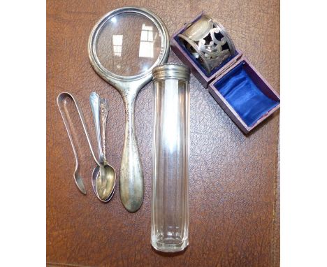 A silver cased magnifying glass, Birmingham 1913; a silver napkin ring, Birmingham 1897, cased; 2 spoons; sugar tongs; a silv