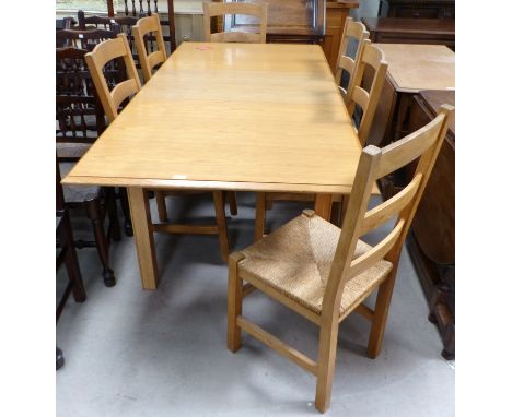 A light oak extending dining table with extra leaf, extended length 77", and 6 rush seat ladder back chairs