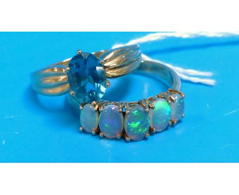 Two 9 carat hallmarked gold dress rings one set with an aquamarine coloured stone, and one with 5 opal coloured stones, 5.5 g