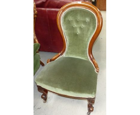 A Victorian mahogany spoon back nursing chair on cabriole legs