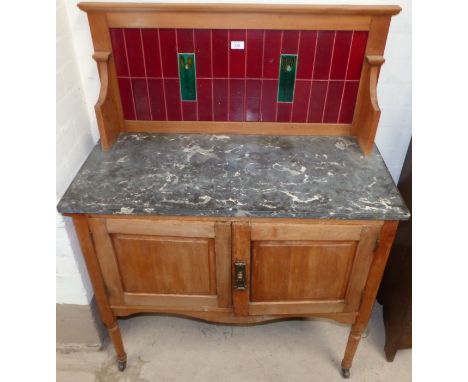 An Edwardian satin walnut washstand with marble top, Art Nouveau tile back and double cupboard`