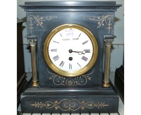 A 19th century black marble architectural mantel clock with brass pillars, white enamel dial and French drum movement
