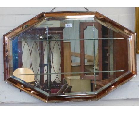 An Art Deco octagonal wall mirror in peach glass frame