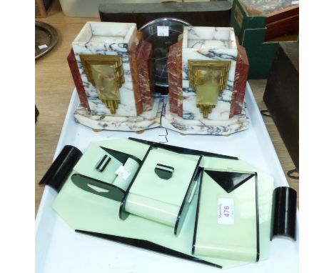 An Art Deco green and black plastic desk set; a pair of Art Deco style coloured marble pedestals; an oak cased mantel clock