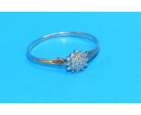 A 9 carat hallmarked gold dress ring with 3 tiers of diamonds in flower head setting