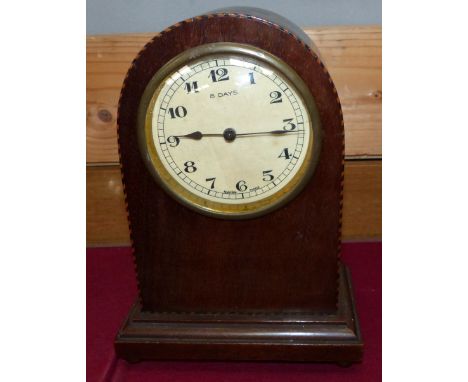 An Edwardian inlaid mahogany arch top mantel clock; an oak Westminster chiming mantel clock; a period style wall clock