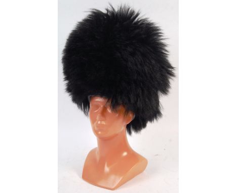 A good vintage 20th century Guard's Bearskin uniform helmet / busby / cap. Cane construction, with original bearskin covering