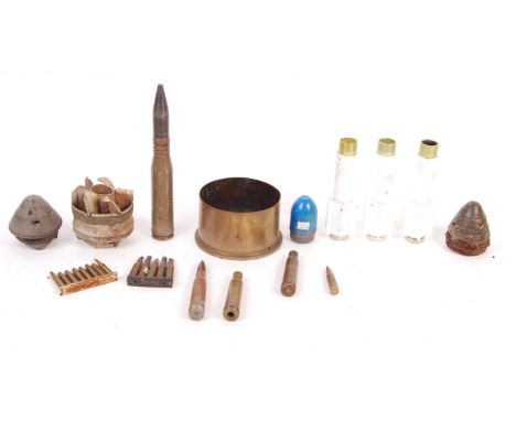 A collection of assorted vintage inert ordnance / munitions. To include some WWI Fuses, shell heads, bullets, rocket fins / t