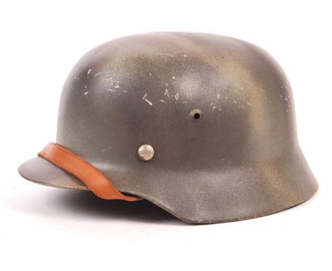 A replica WWII Second World War Nazi Third Reich Army ' Stahlhelm ' steel uniform helmet. Camouflage paint, complete with lin