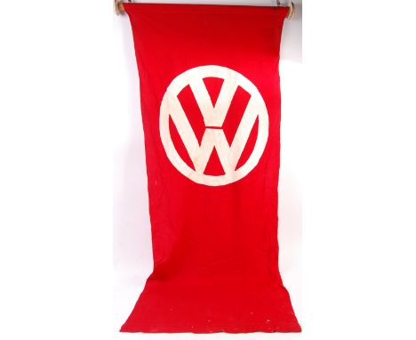 An original vintage 20th Century car showroom sale forecourt flag having the VW Volkswagen logo to the top in white with a re
