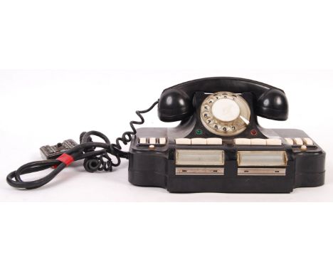 An original WWII Second World War era German base camp switchboard telecom telephone of larger form having a ring dial with w