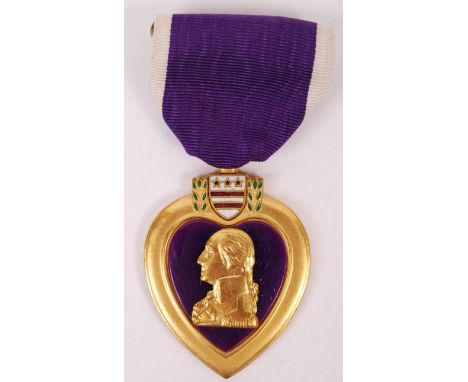 A WWII Second World War US Army Purple Heart medal awarded to a Coy Vern Stinnett who was awarded a Bronze Star and Oak Leaf 
