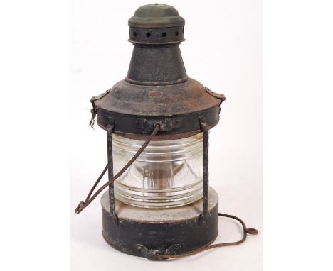 An original early 20th century ships lantern lamp light of circular form. Copper construction with swing handle to top of chi