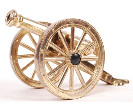 A reproduction scale desktop black powder naval cannon having brass wheels and brass barrel with lion, armorial shield and ' 