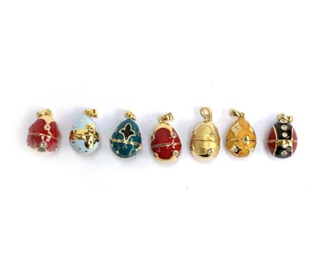 A collection of seven Russian egg style 'Midas Renaissance Egg' silver and enamel pendants, each set with natural white zirco