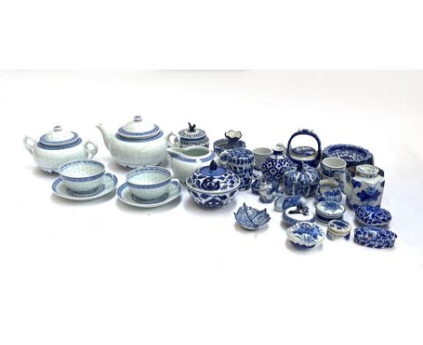 A Chinese rice ware teapot, sugar bowl, milk jug, and two cups and saucers; together with a quantity of blue and white cerami